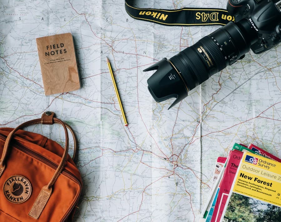 Travel maps, a camera, and a notebook laid out for planning